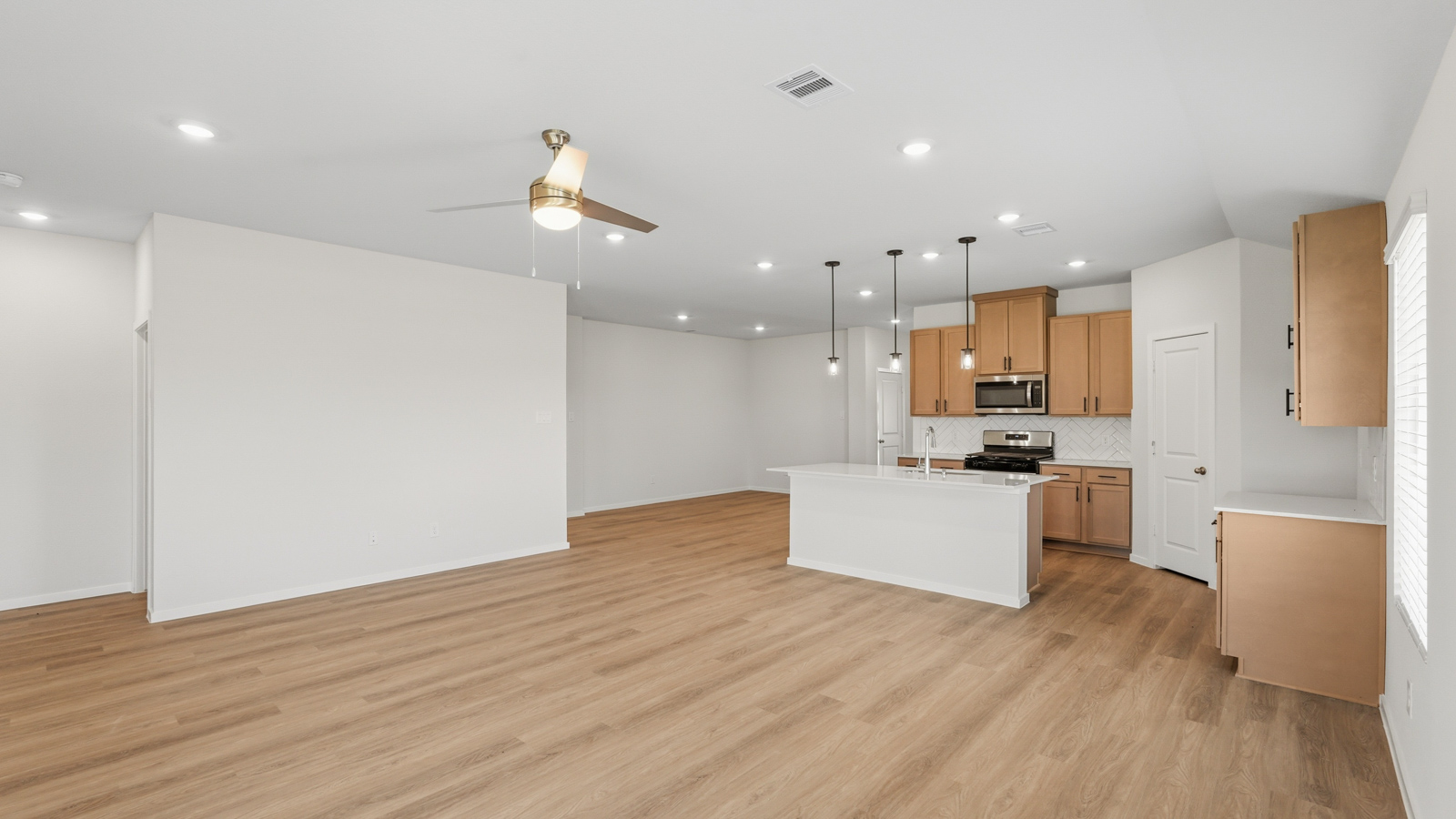open concept living and dining area with vinyl flooring