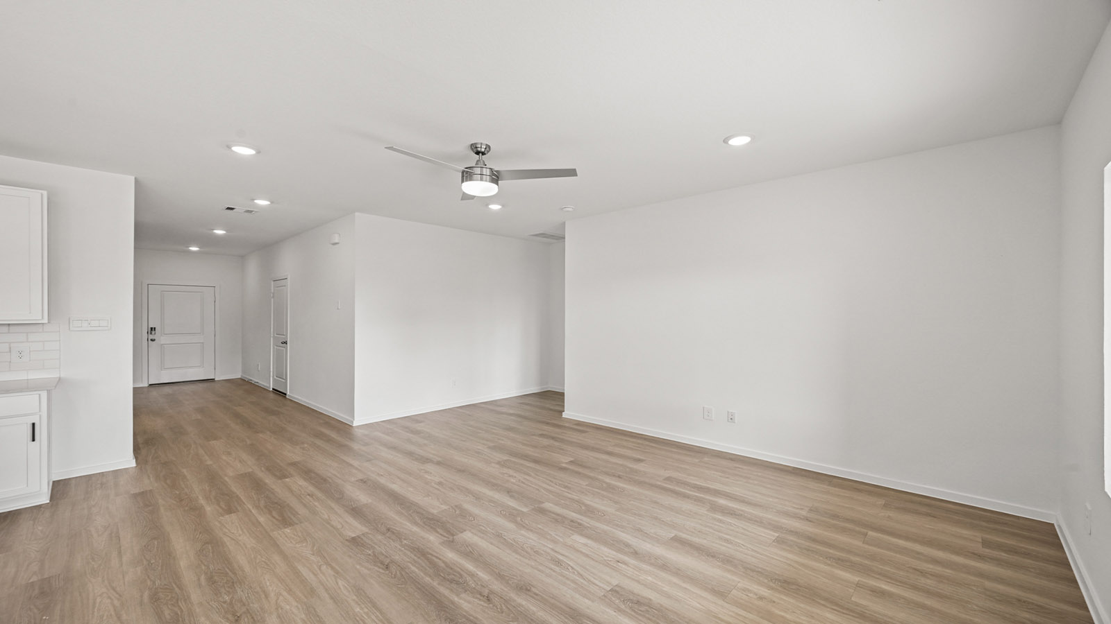 open concept living and dining area with pendant lights, quartz countertops, and large windows