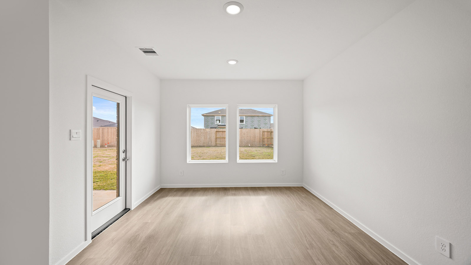 open concept living and dining area with pendant lights, quartz countertops, and large windows