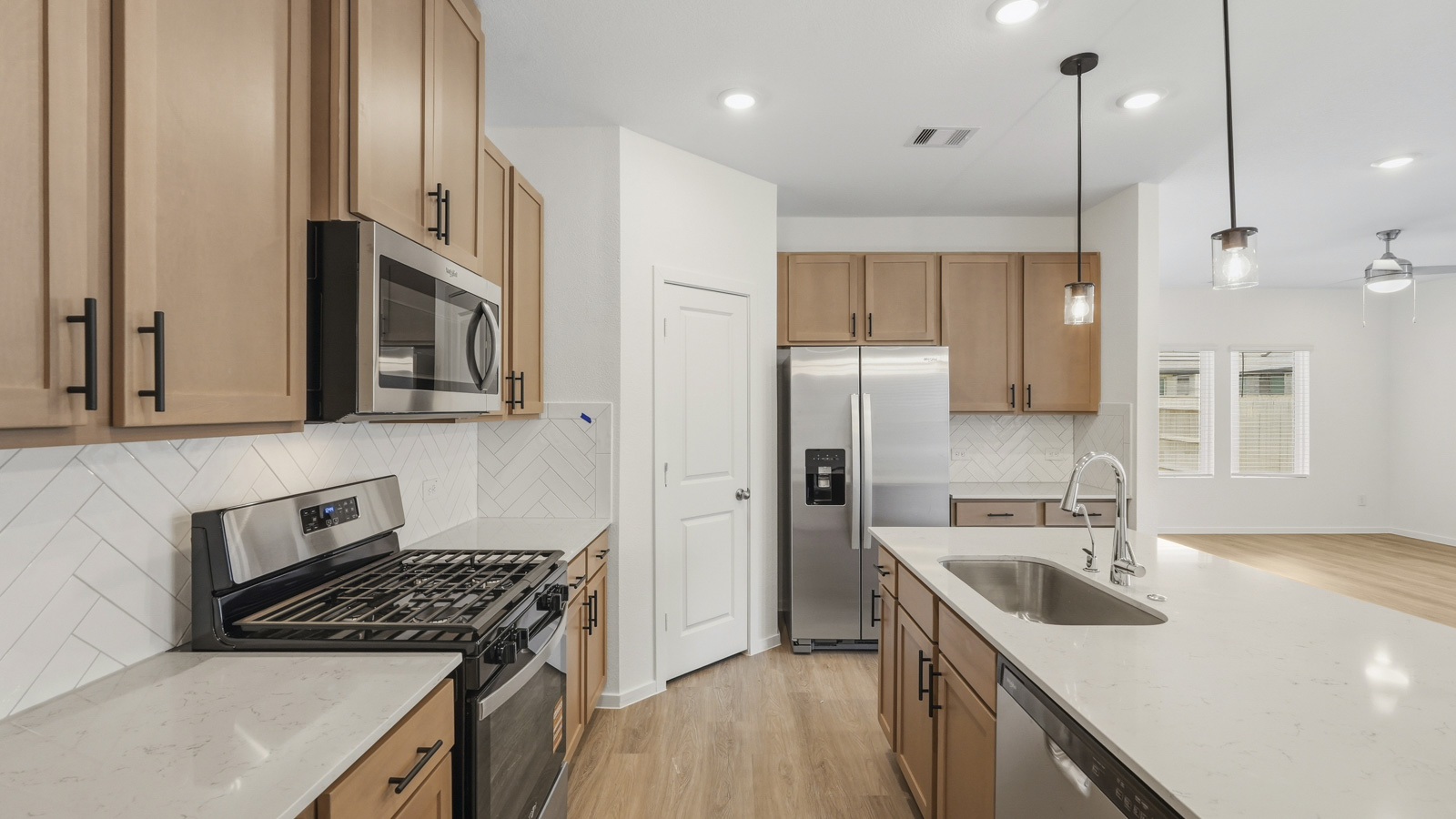 open concept living and dininga rea with vinyl flooring, quartz countertops, and large windows