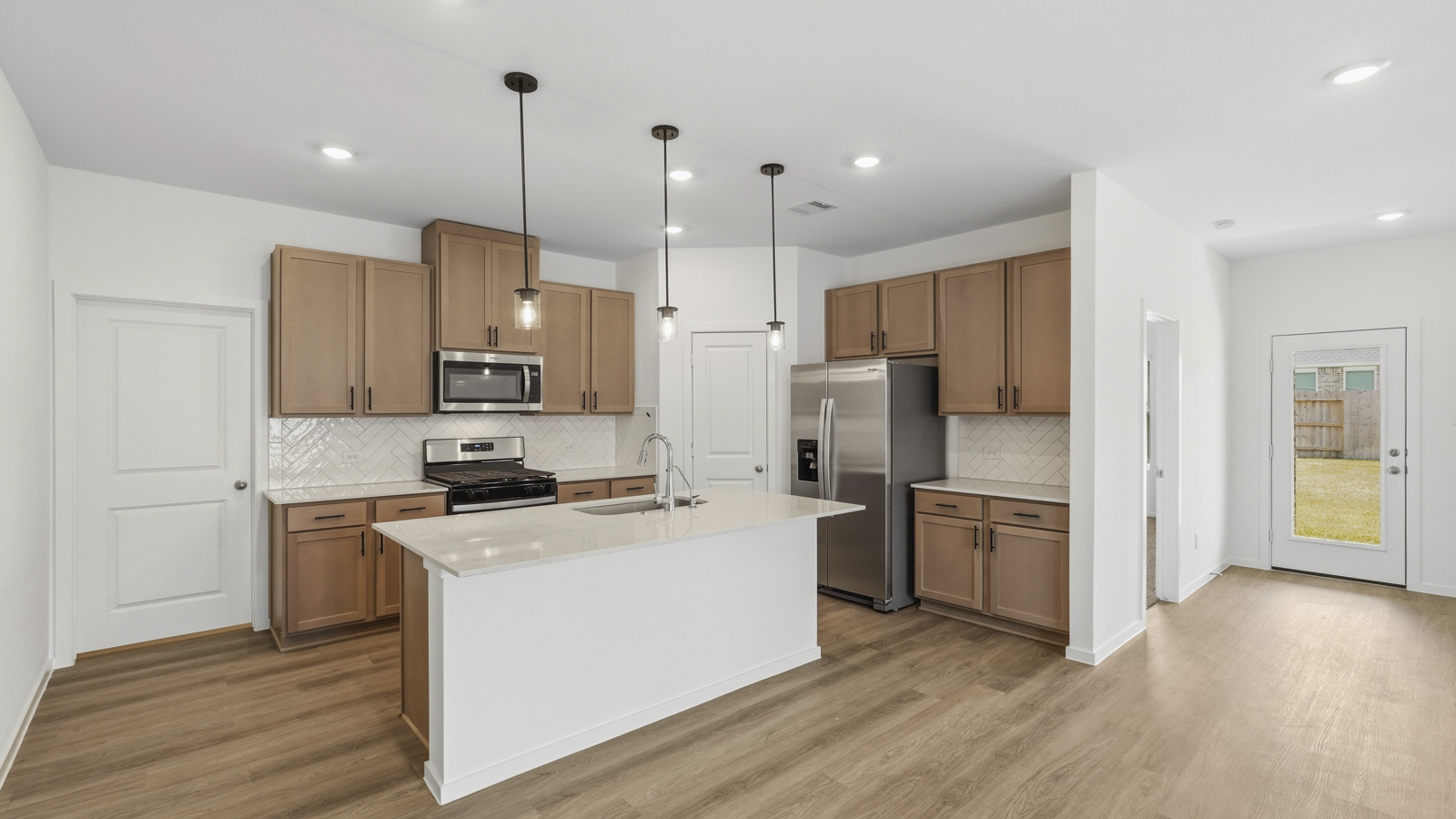 open concept living and dininga rea with vinyl flooring, quartz countertops, and large windows