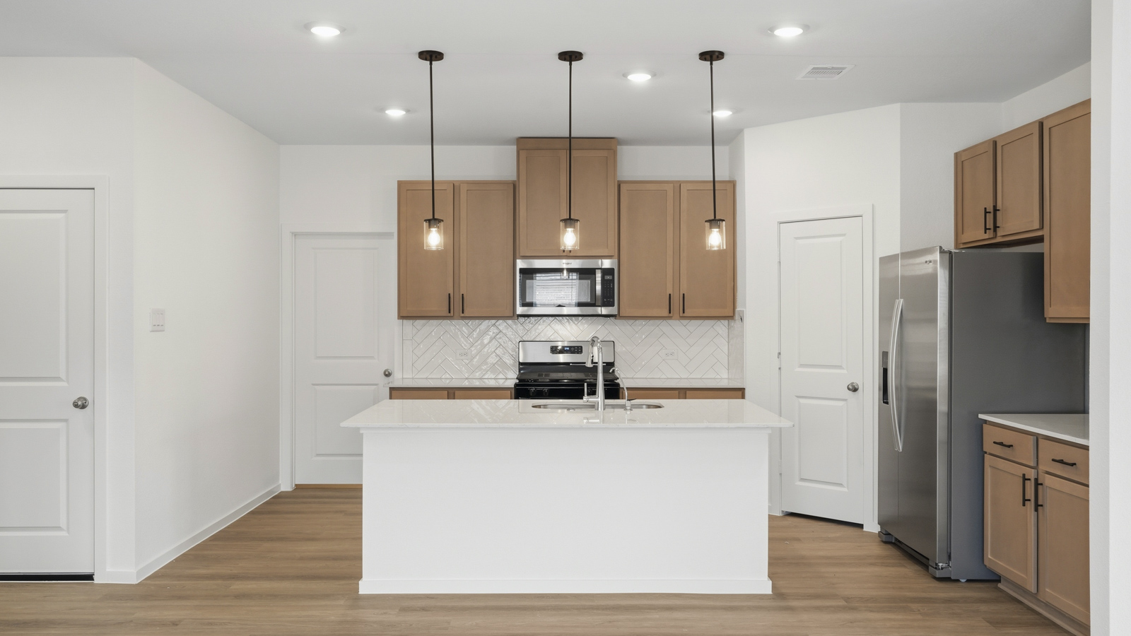 open concept living and dininga rea with vinyl flooring, quartz countertops, and large windows