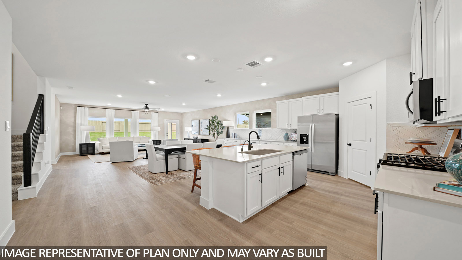 open concept living and dining area with vinyl flooring, quartz countertops, and large windows