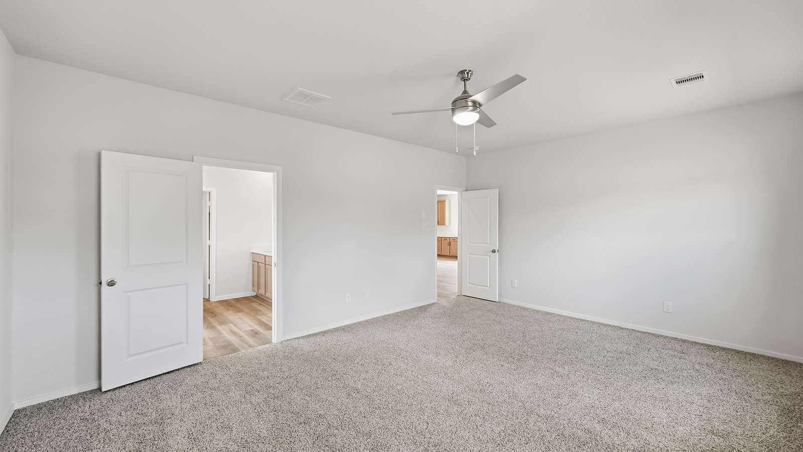 Primary bedroom with carpet flooring and window in Hockley, TX