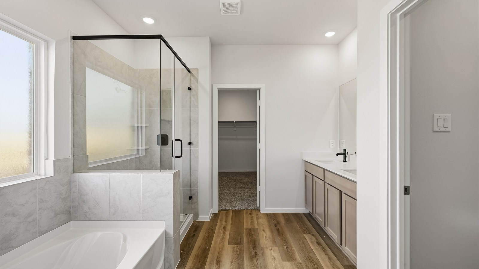 primary bathroom with separate tub and shower