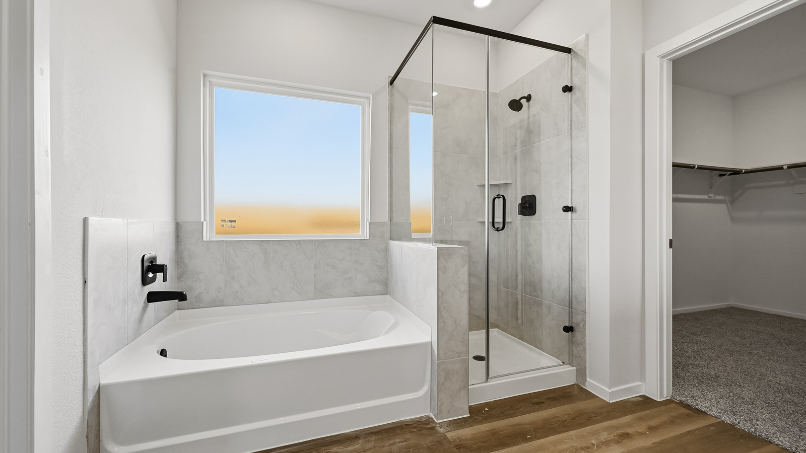 primary bathroom with separate tub and shower