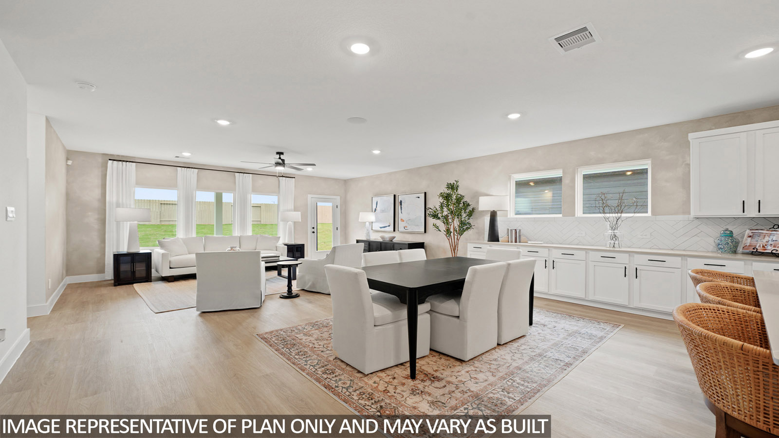 open concept living and dining area with vinyl flooring, quartz countertops, and stainless steel appliances in Hockley, TX