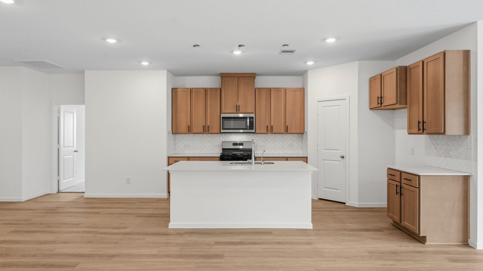 open concept living and dining area with vinyl flooring, quartz countertops, and large windows