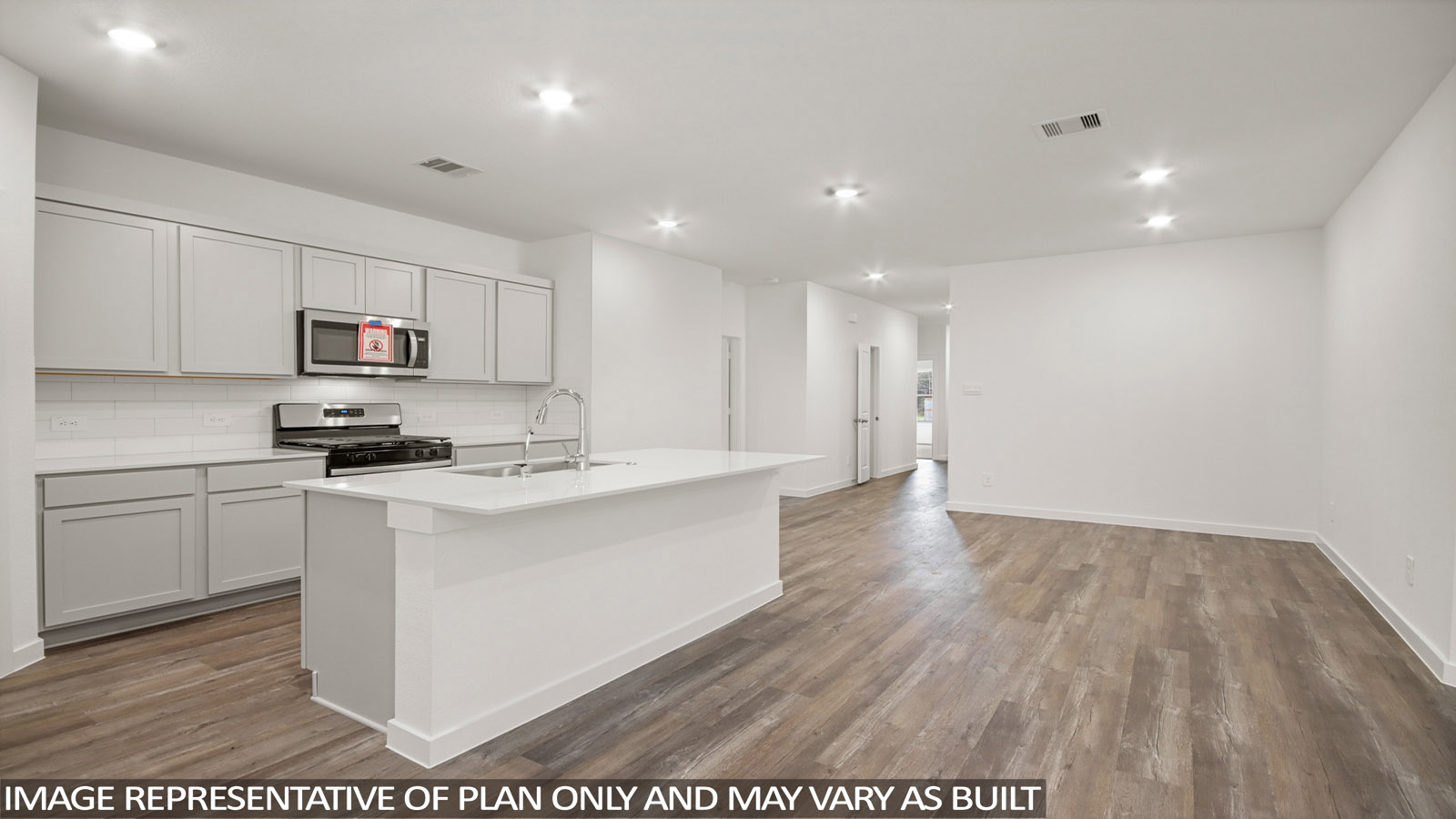 open concept livivng and dining area with vinyl flooring, quartz countertops, and large windows