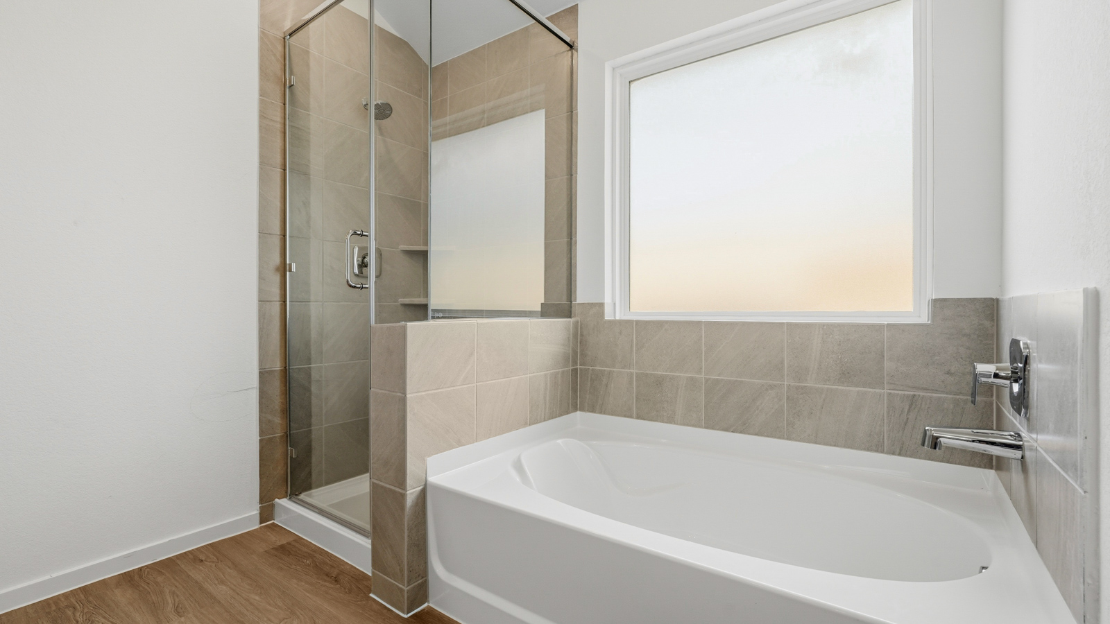 primary bathroom with separate tub and shower