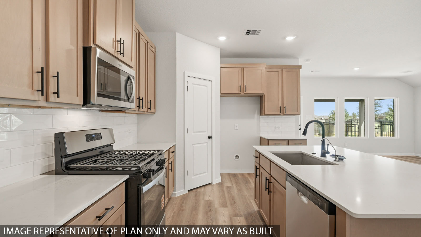 open concept living and dining area with large windows