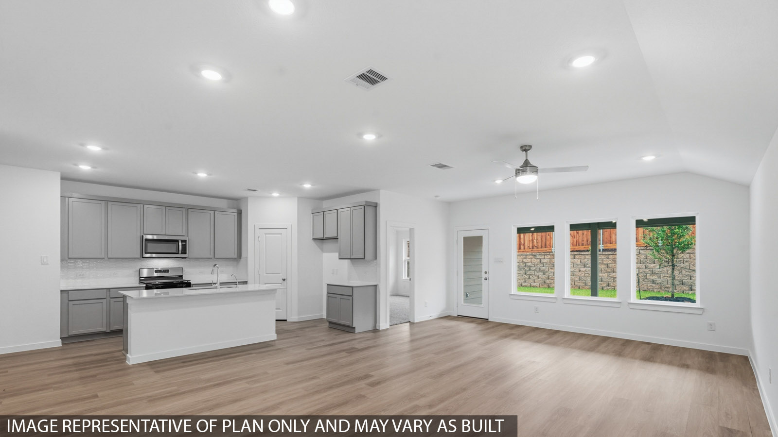 open concept living and dining area with large windows