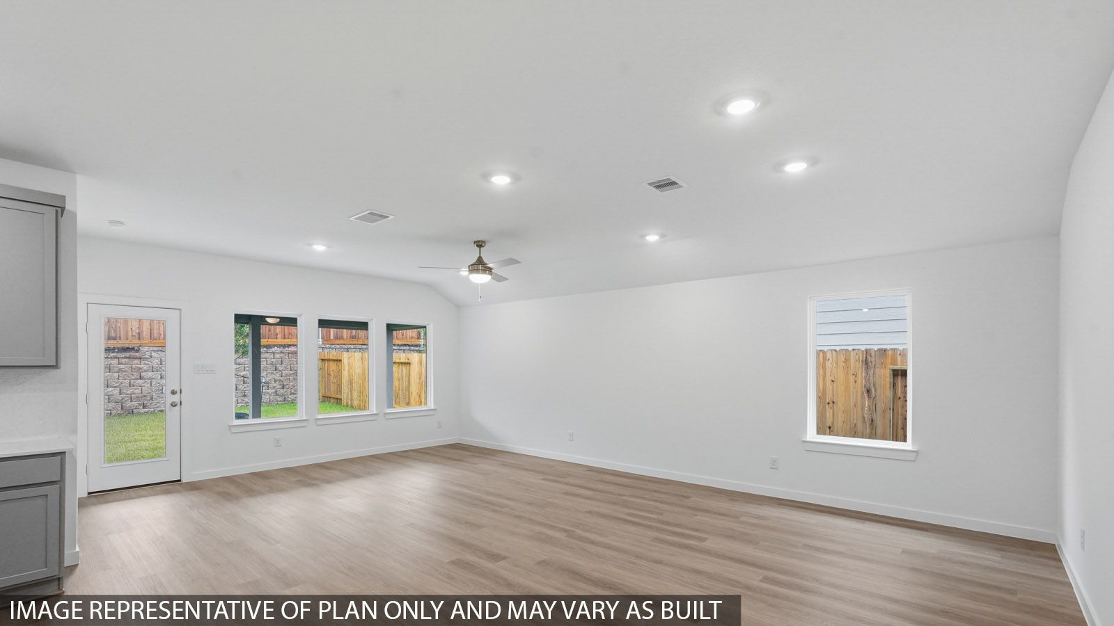open concept living and dining area with vinyl flooring, large windows, and vinyl flooring