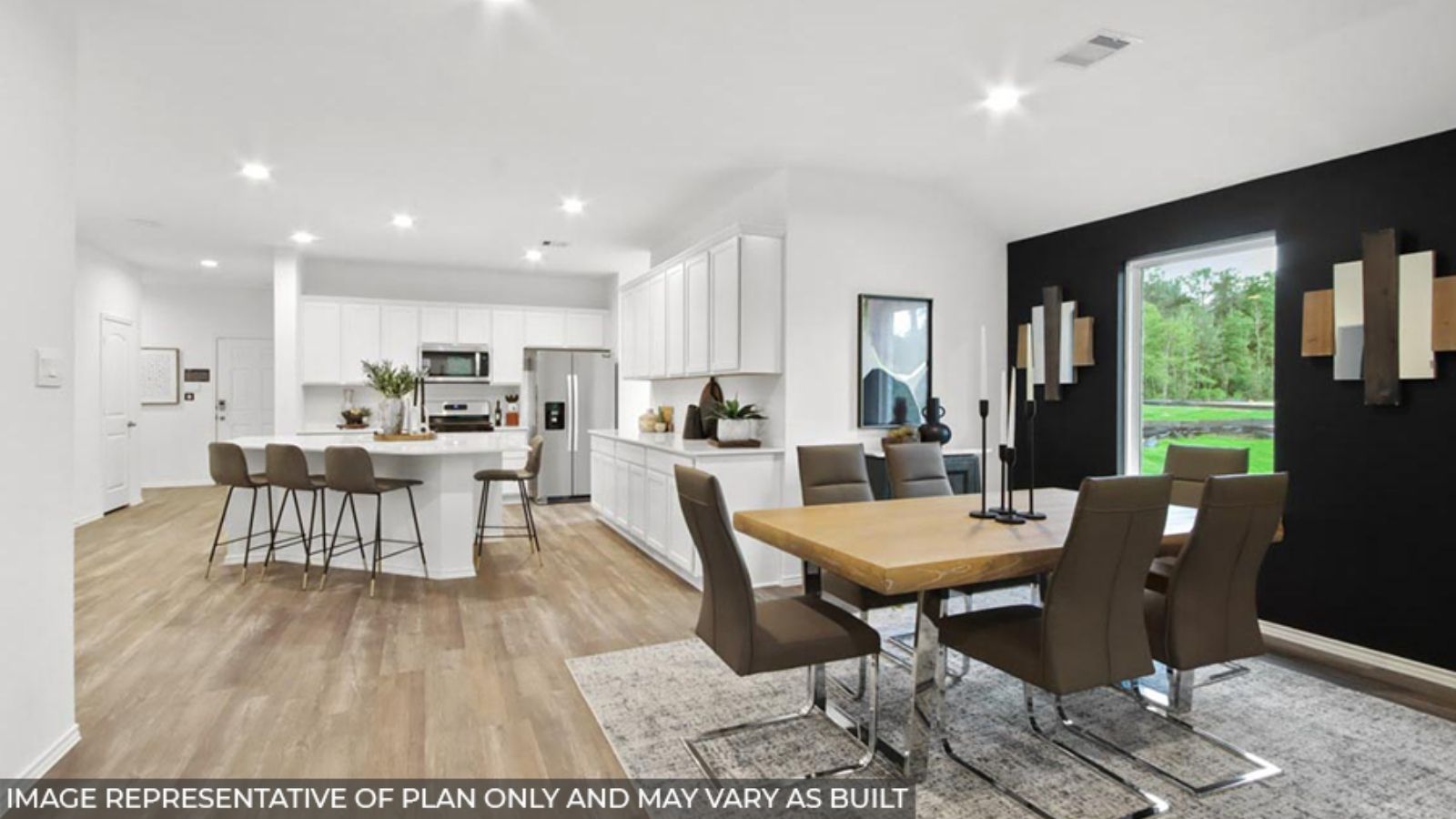 open concept living and dining area with quartz countertops, stainless steel appliances, and vinyl flooring