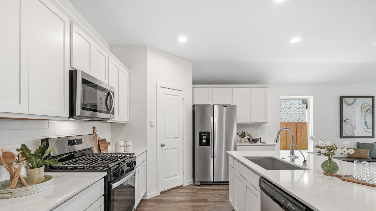 luxury kitcen with Whirlpool stainless steel appliances and quartz countertops in Katy, Tx