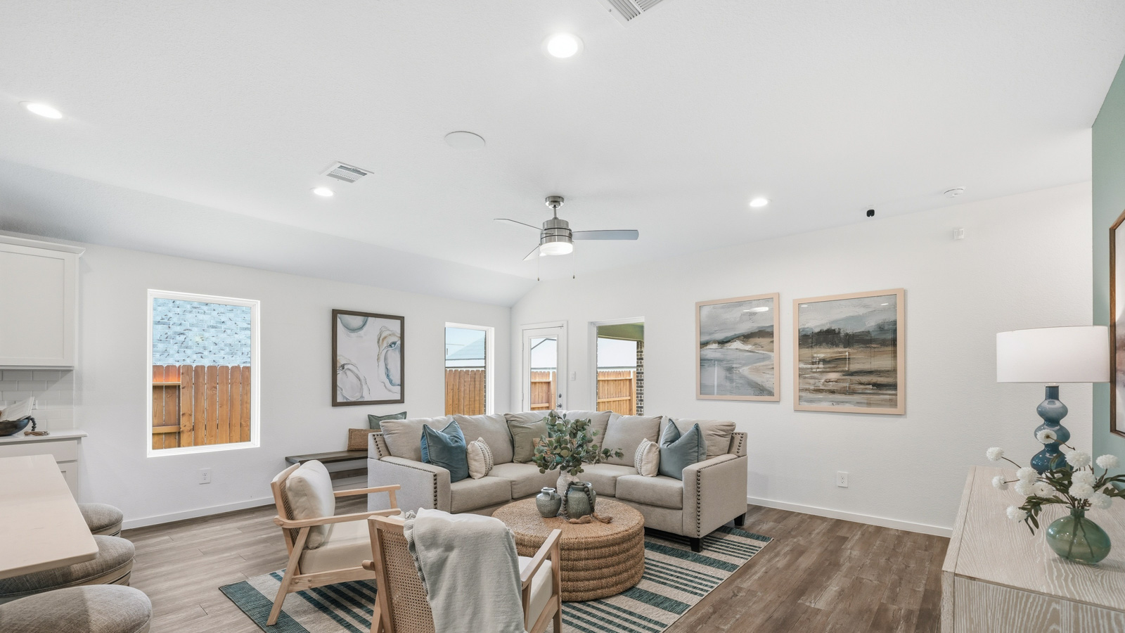 open concept living and dining area with Mohawk flooring and large windows