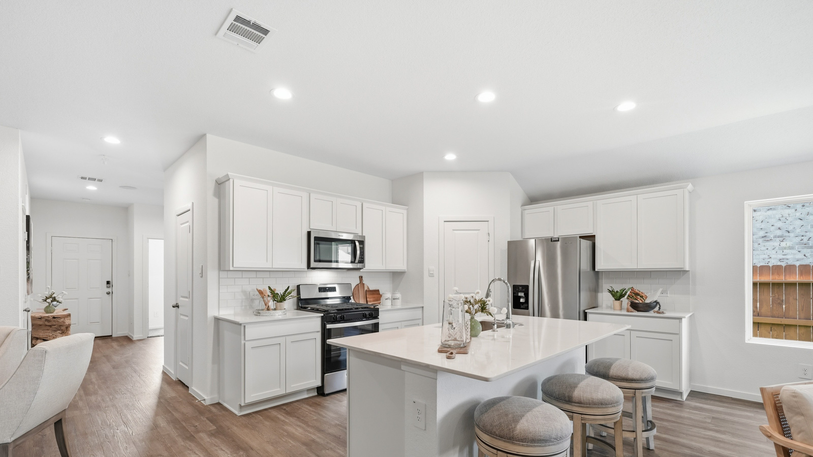 luxury kitcen with Whirlpool stainless steel appliances and quartz countertops in Katy, Tx
