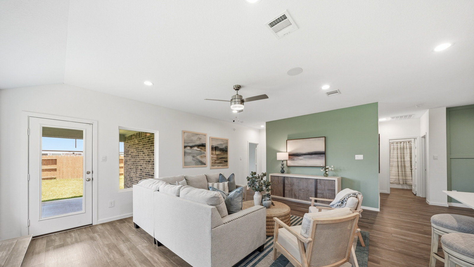 open concept living and dining area with Mohawk flooring and large windows