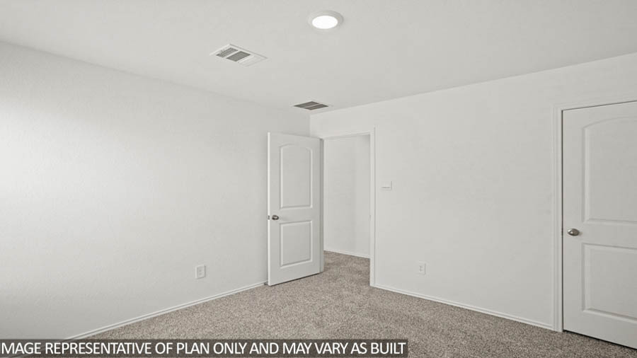 Secondary bedroom with white walls, windows, and light carpet.