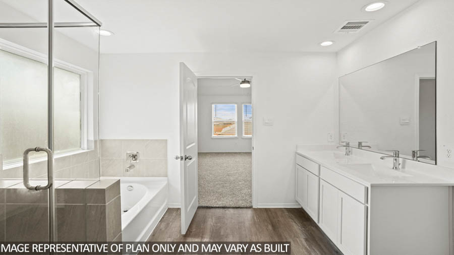 Primary bathroom with dual sinks, shower, tub, white cabinets, white walls, and vinyl wood flooring.