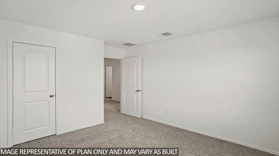 Secondary bedroom with white walls, windows, and light carpet.
