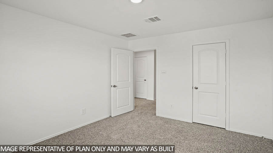 Secondary bedroom with white walls, windows, and light carpet.