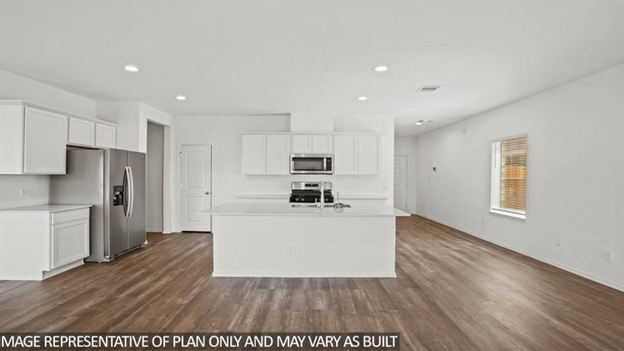 Open kitchen with an island, stainless steel appliances, white cabinets, white walls, and vinyl wood flooring.