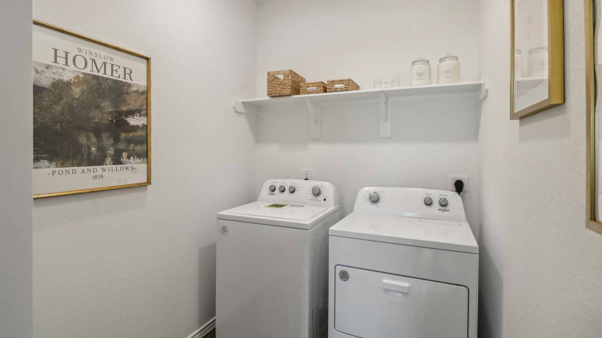 Laundry room with white walls and vinyl wood flooring.