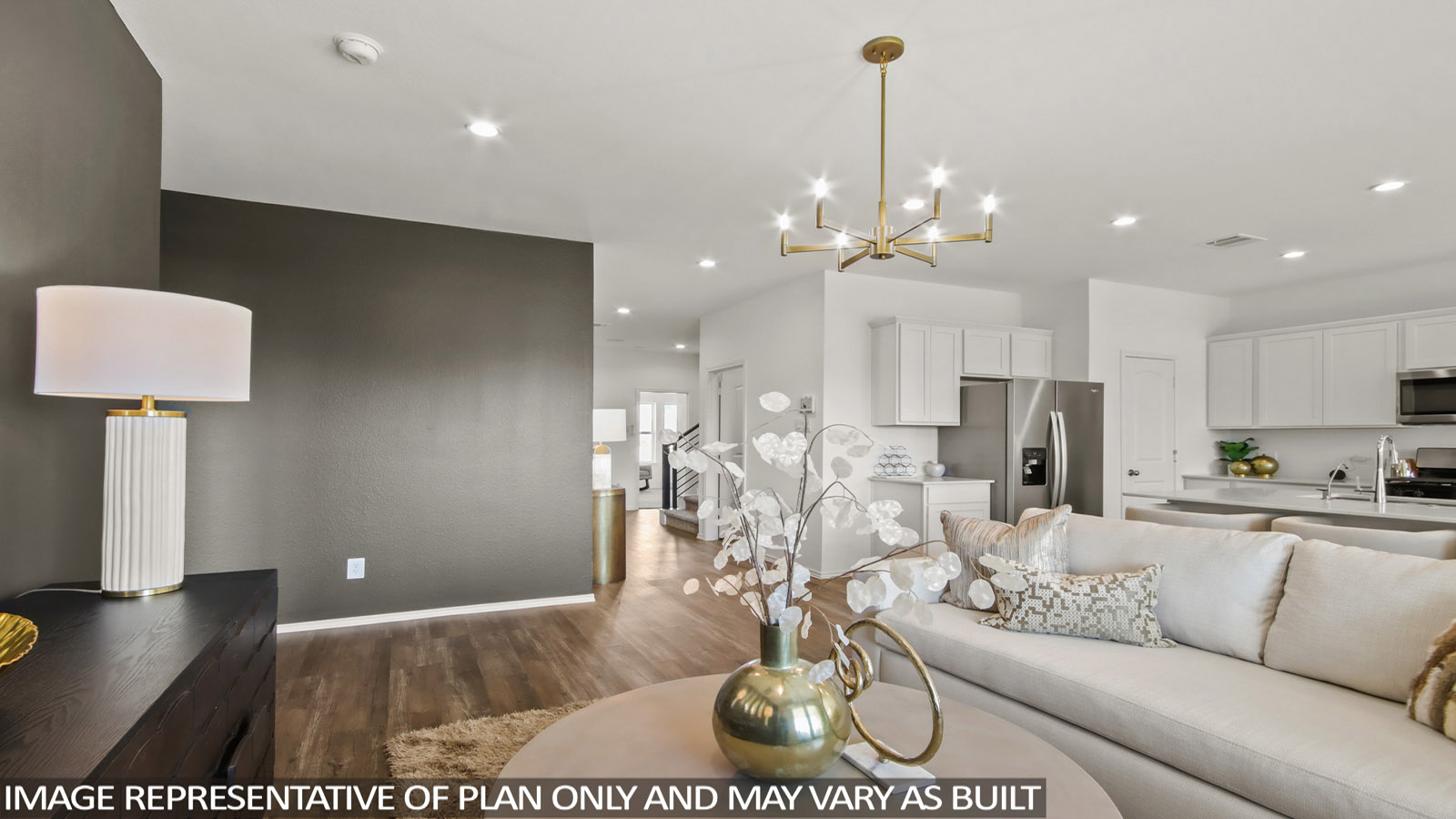 Spacious living area with a brown accent wall and a white couch.