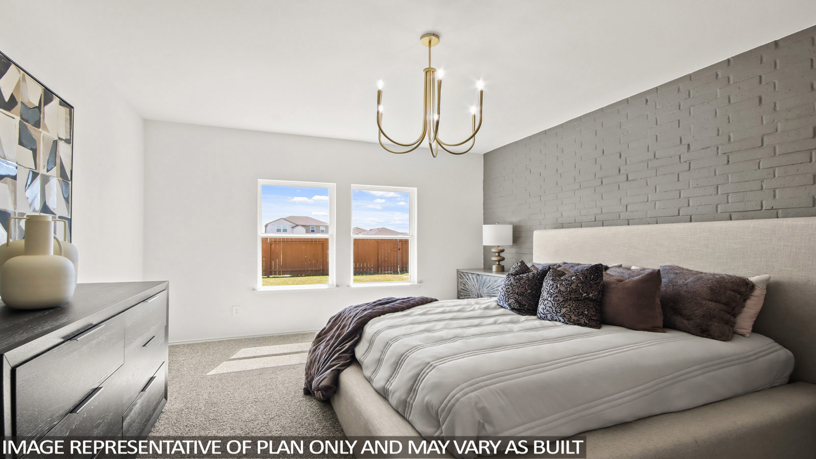 Bedroom with a large bed, dresser, and two windows.