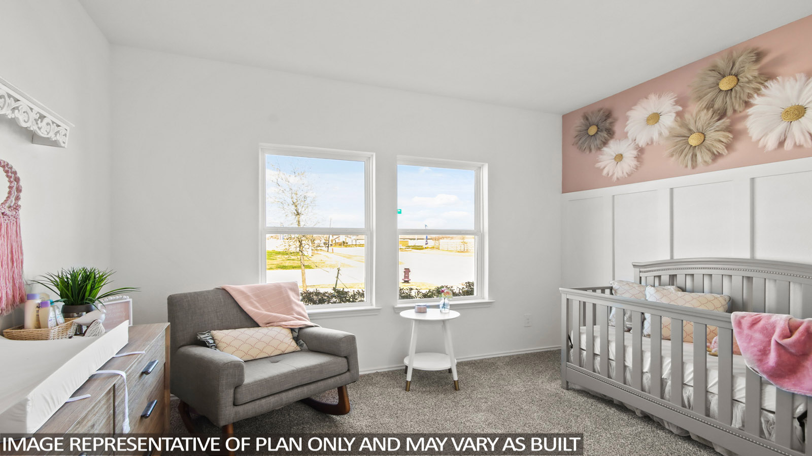 Bedroom with a gray crib, rocking chair, and two large windows.