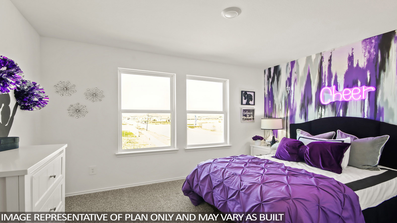 Bedroom featuring a bed with purple bedding, a night stand, and a white dresser.