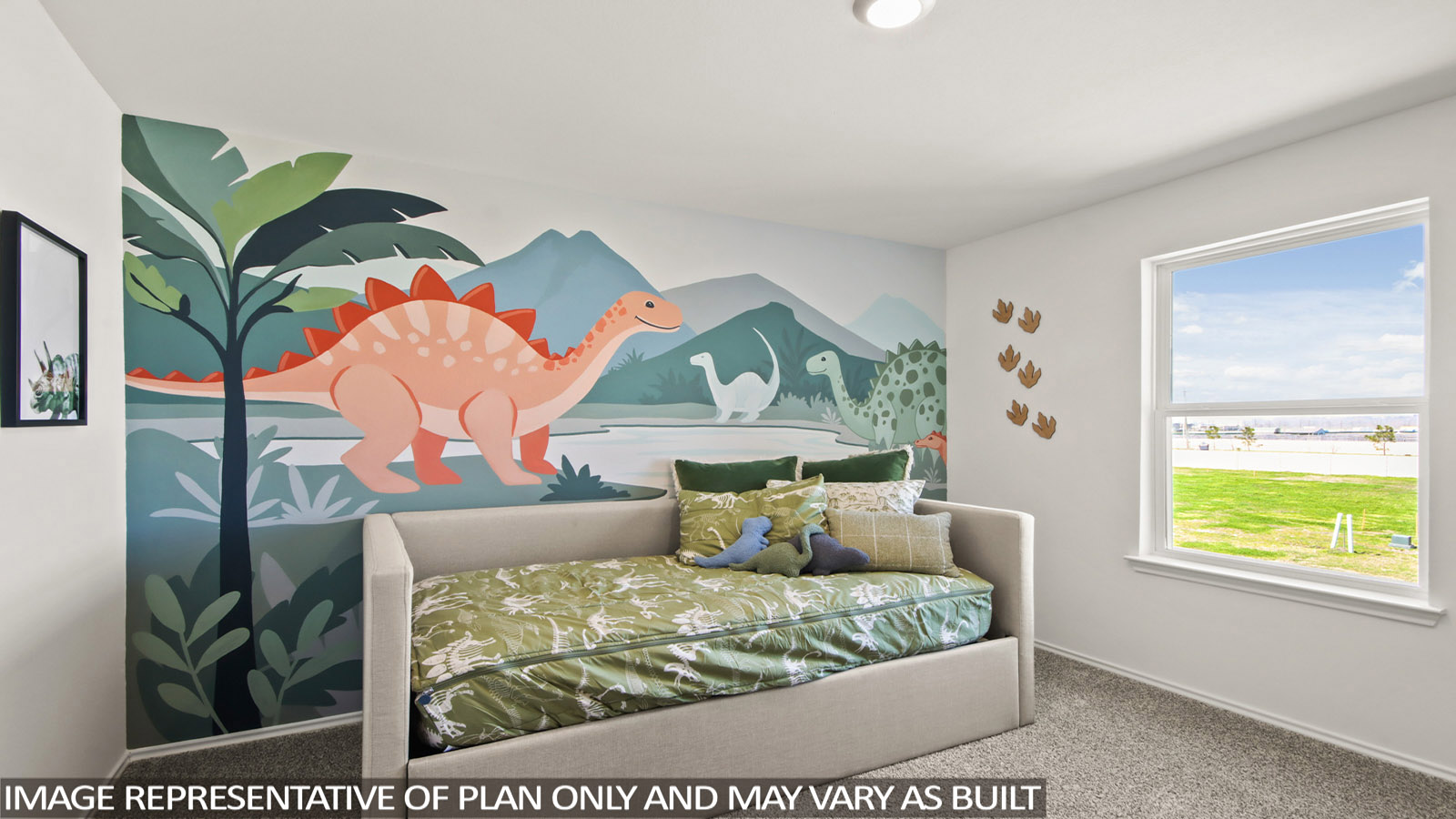 Bedroom featuring a bed, large window, and a wall with dinosaurs on it.