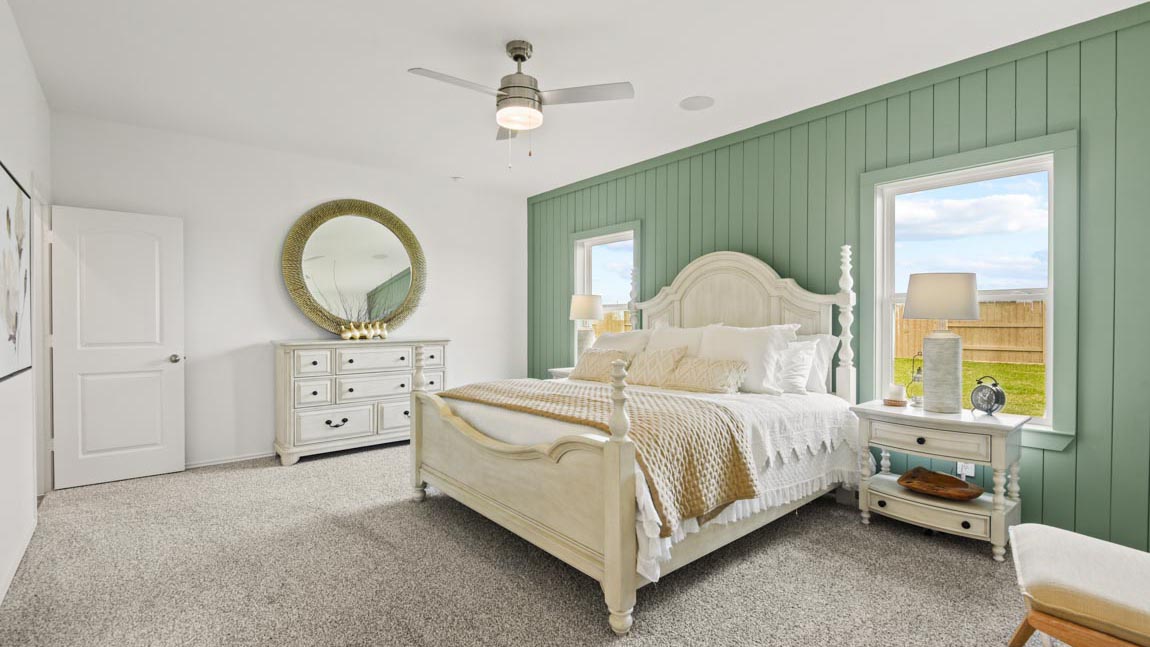Bedroom with a large bed with white bedding, two nightstands, and a dresser.