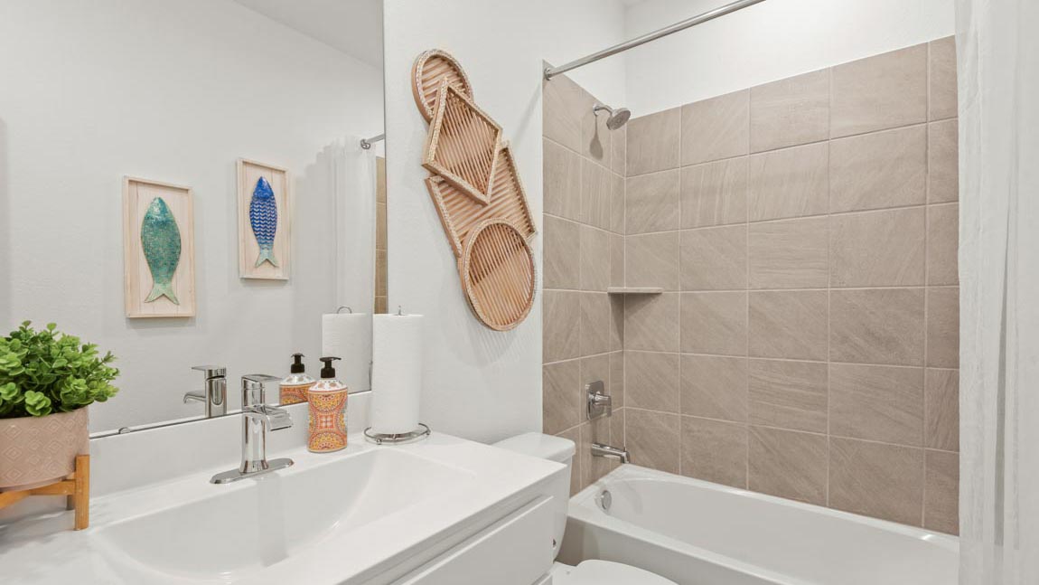 Bathroom featuring a sink, toilet, and shower tub.