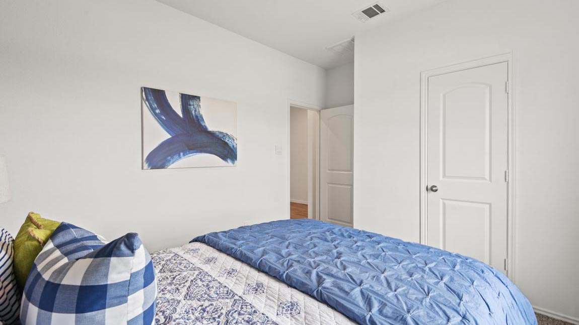 Bedroom featuring a bed with blue bedding.