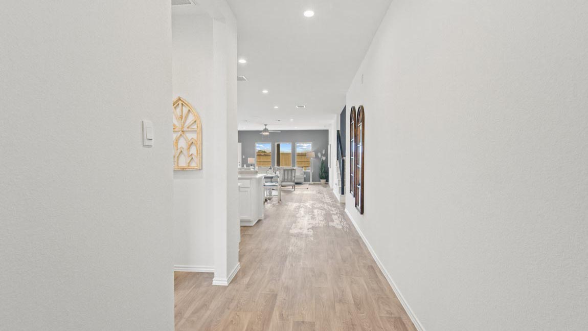 Hallway into the kitchen, dining, and living area.