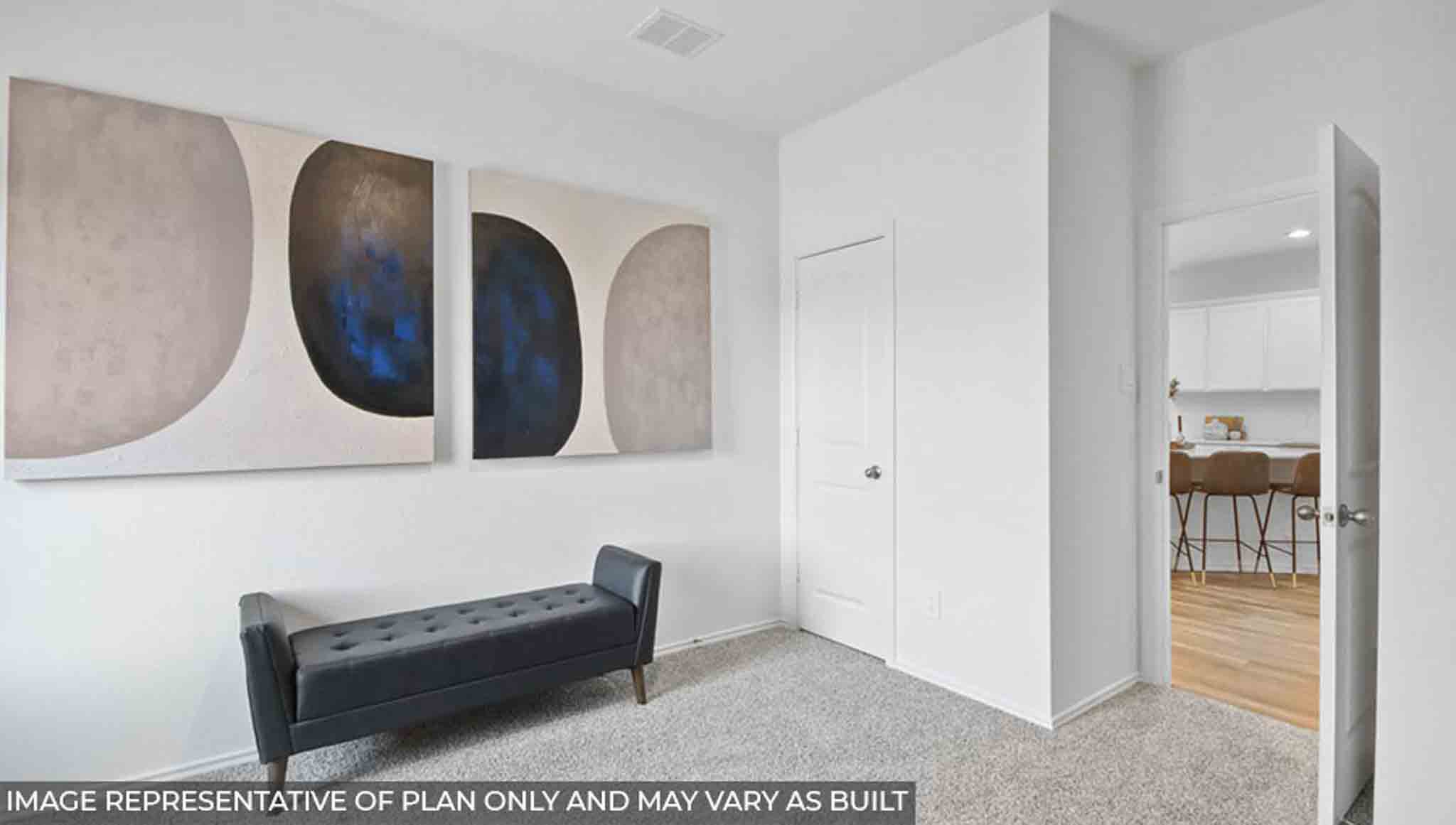 Secondary bedroom with windows, white walls, and light carpet.