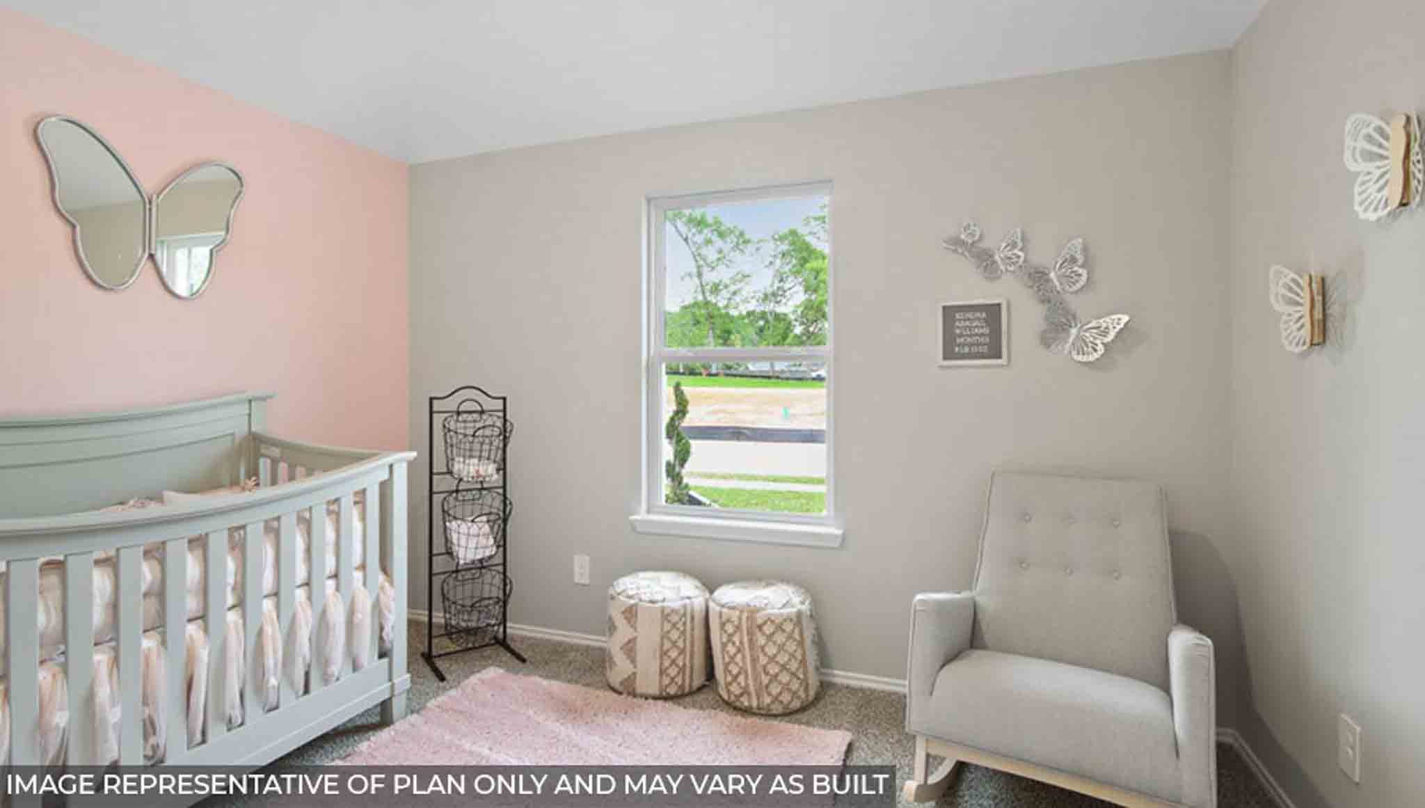 Secondary bedroom with windows, white walls, and light carpet.
