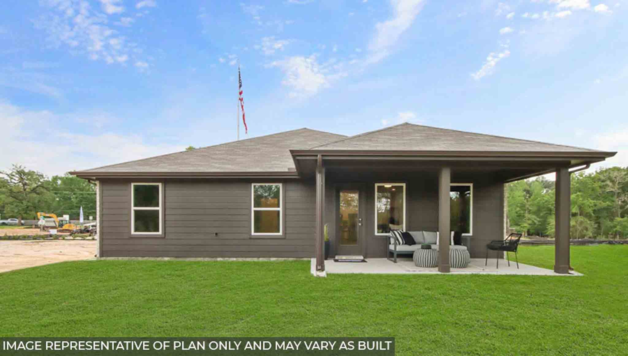 Landscaped backyard with a covered patio.