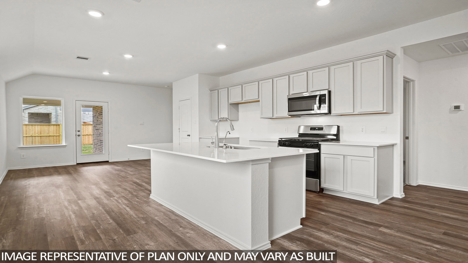 open concept living and dining area with quartz countertops, and stainless steel appliances