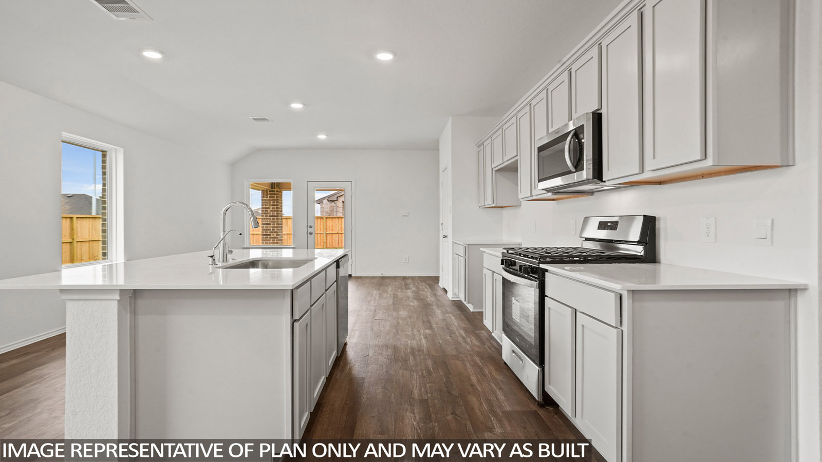 open concept living and dining area with quartz countertops, and stainless steel appliances