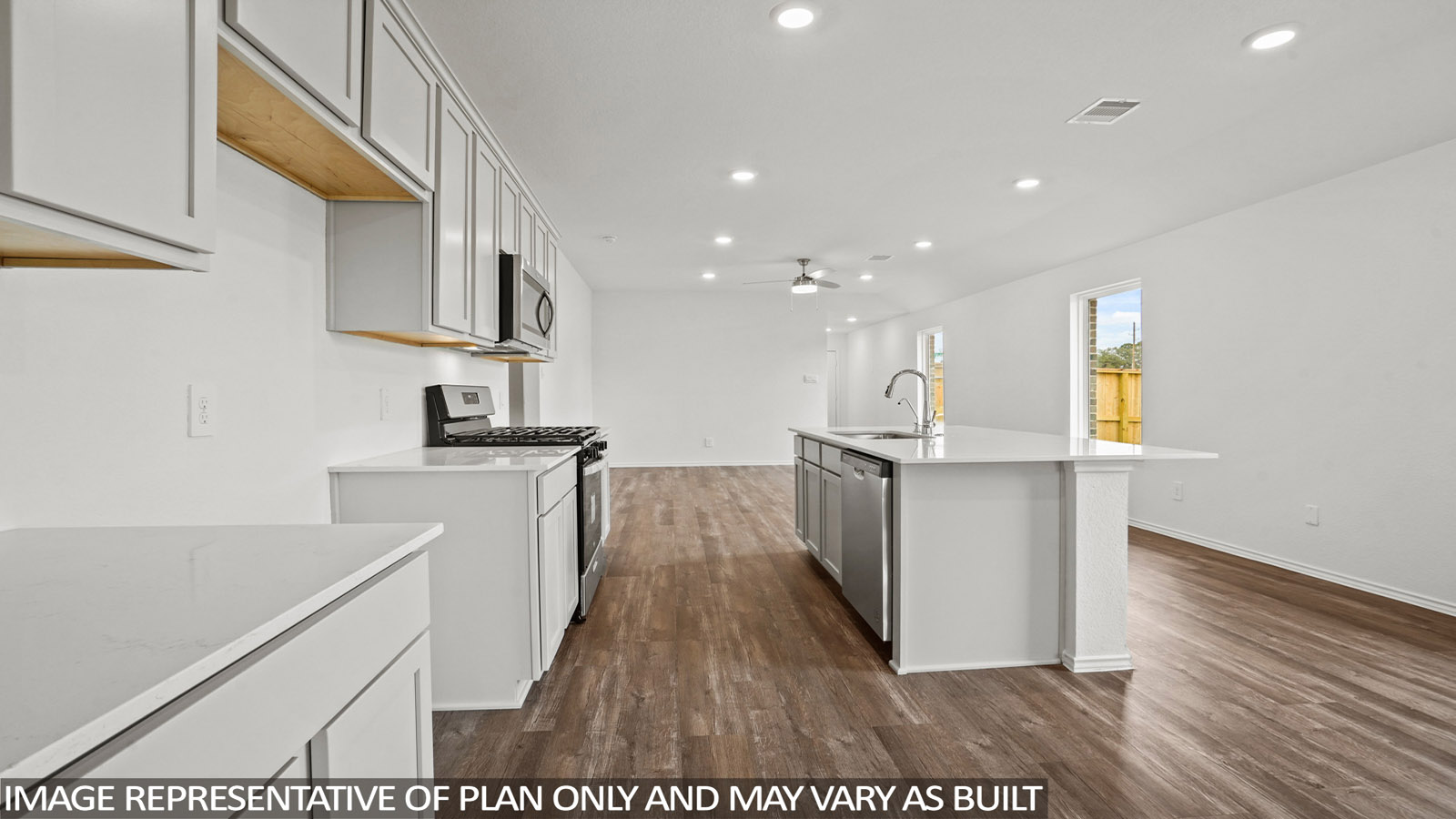 open concept living and dining area with quartz countertops, and stainless steel appliances