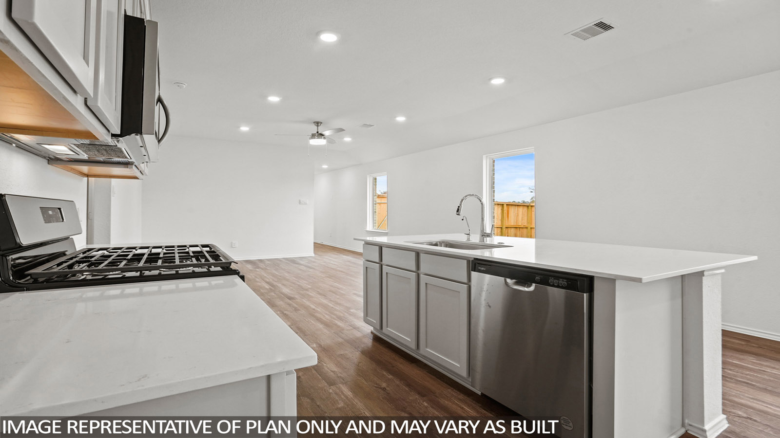 open concept living and dining area with quartz countertops, and stainless steel appliances