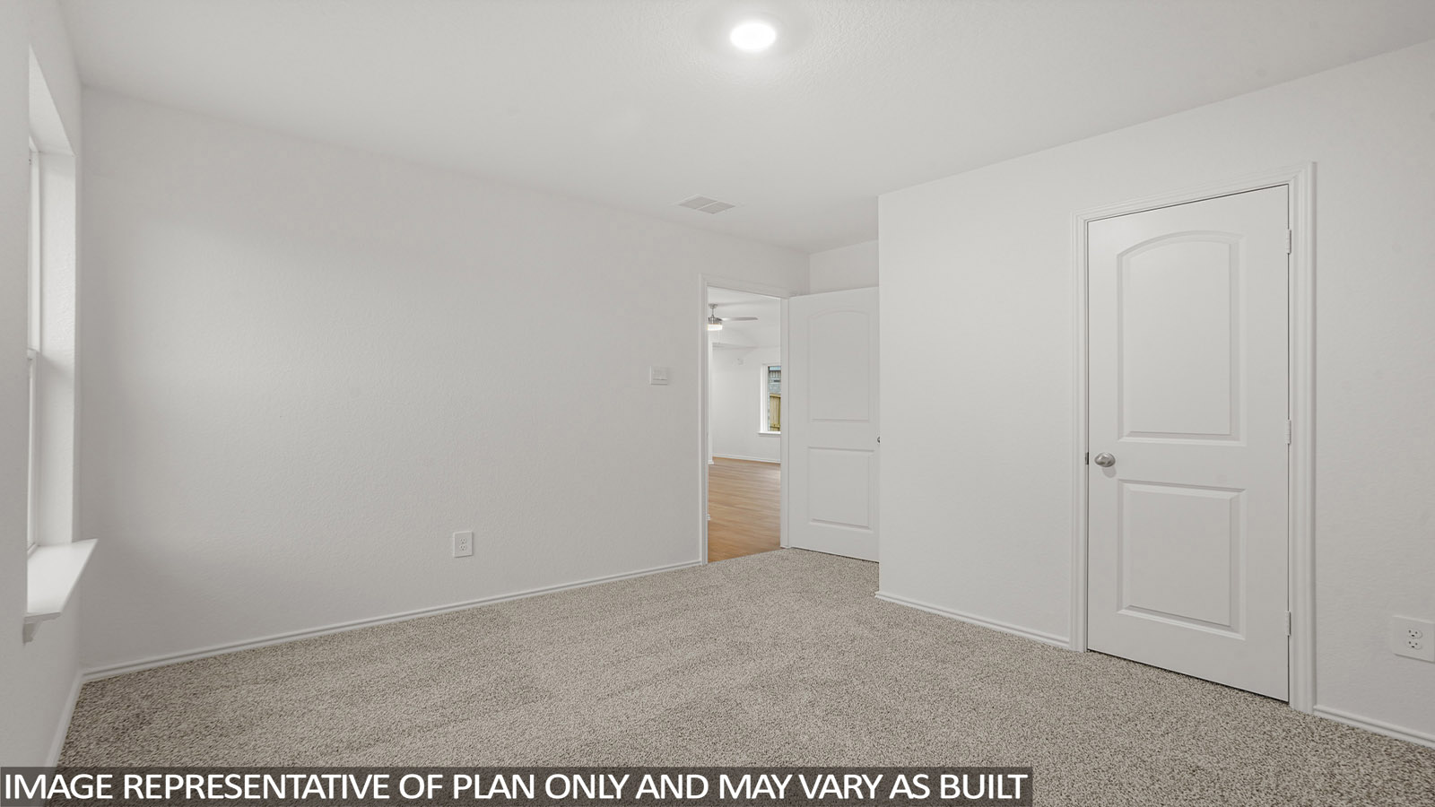 Secondary bedroom with carpet flooring