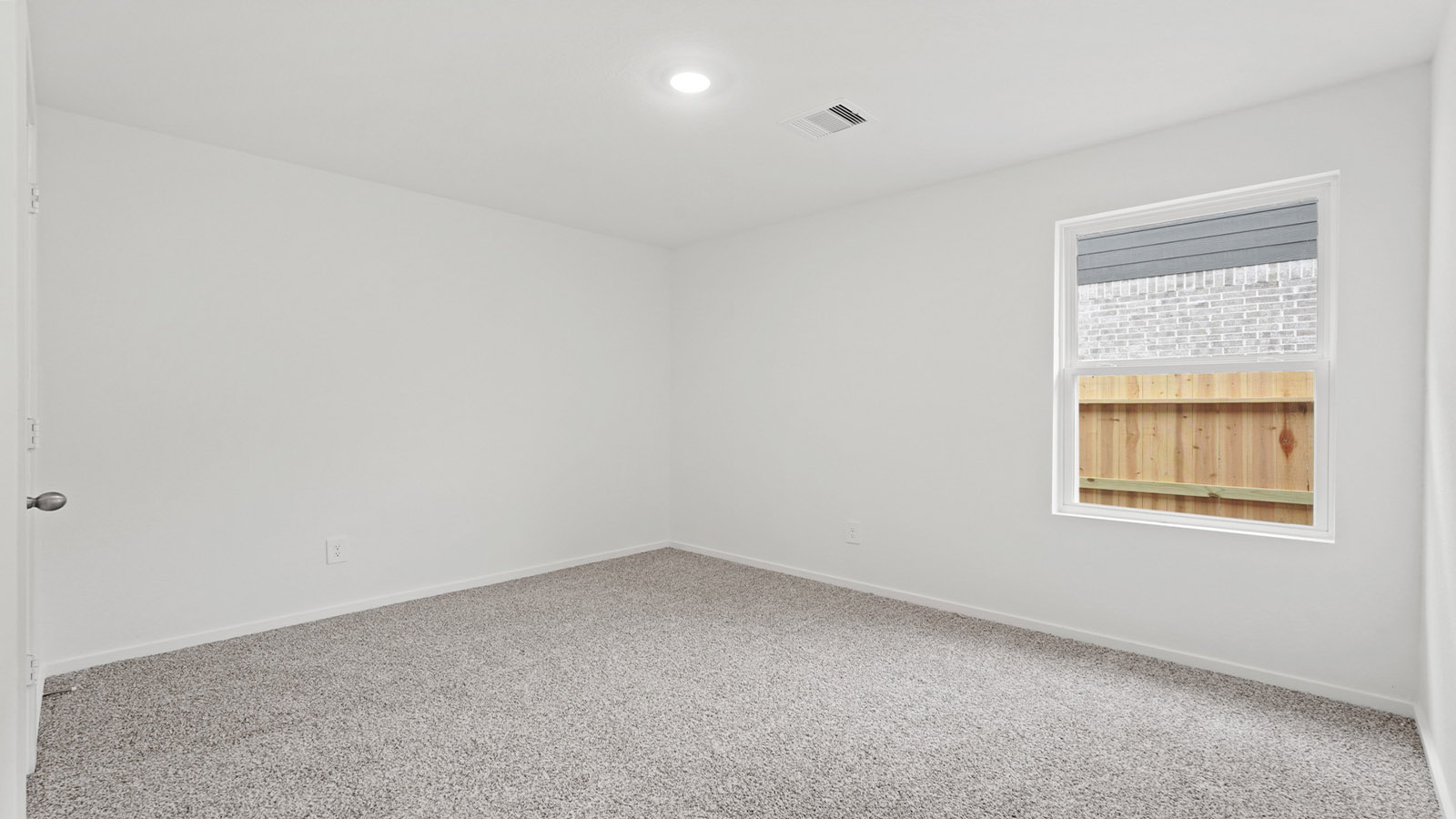 Secondary bedroom with carpet flooring