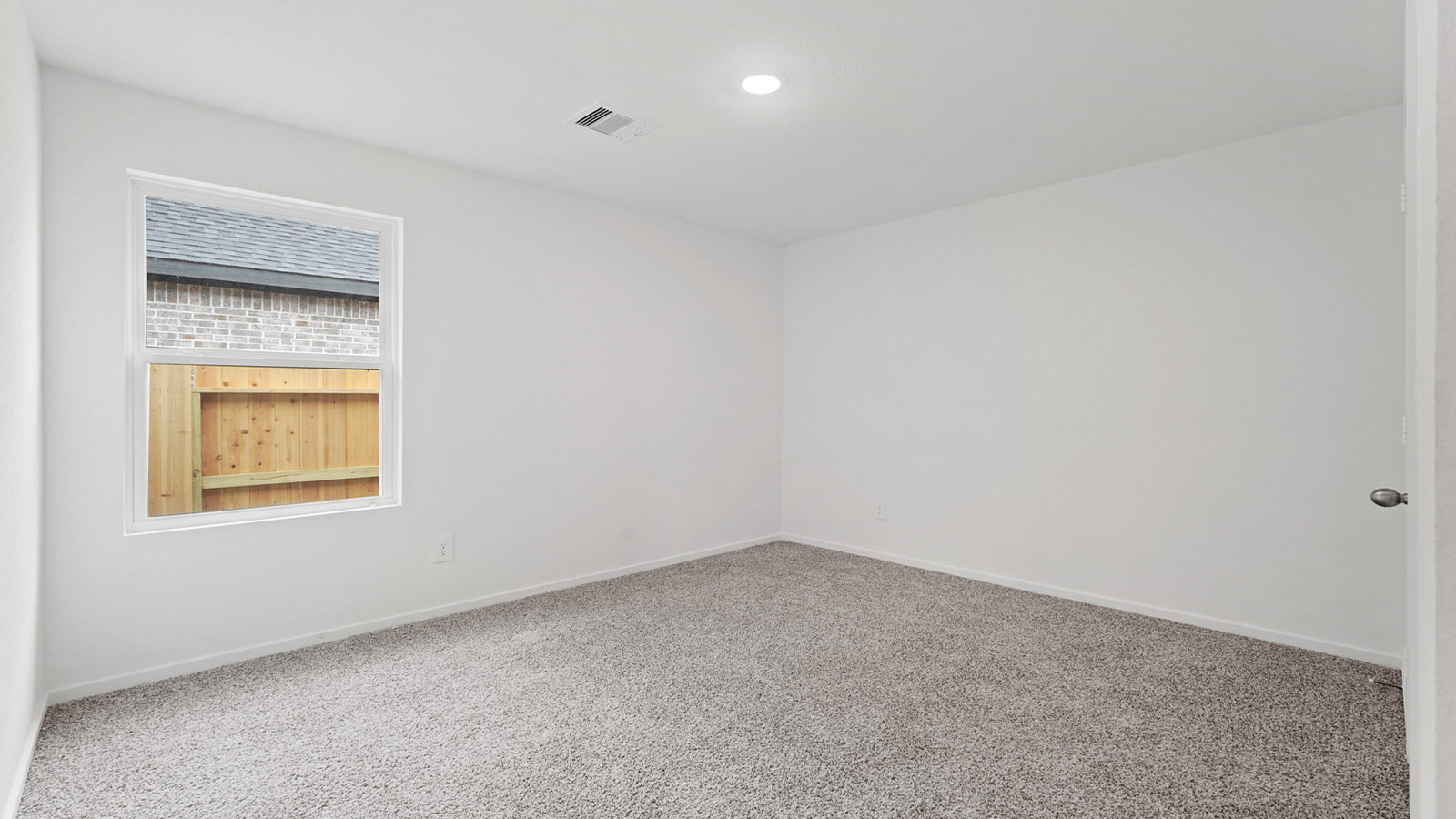 Secondary bedroom with carpet flooring