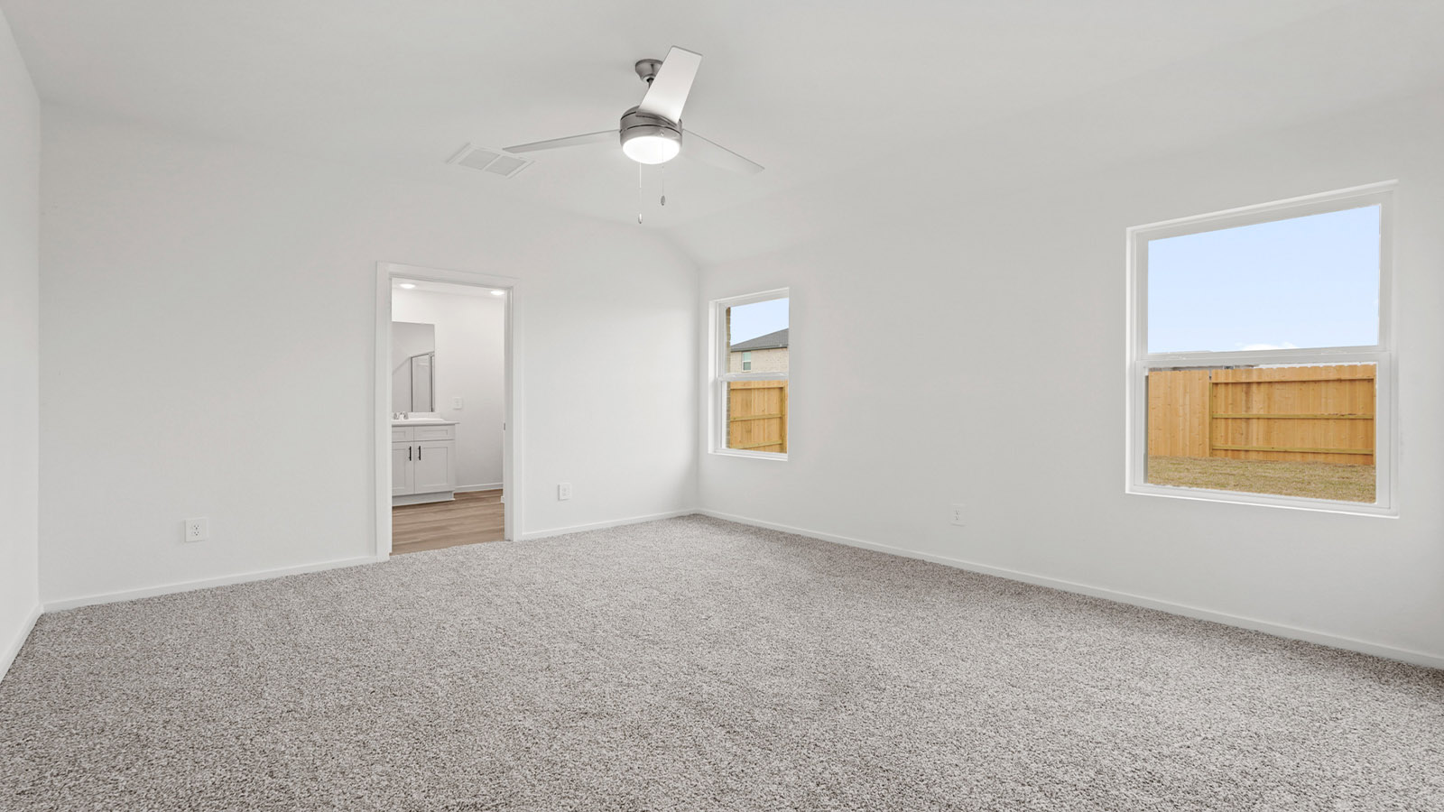 Primary bedroom with carpet flooring