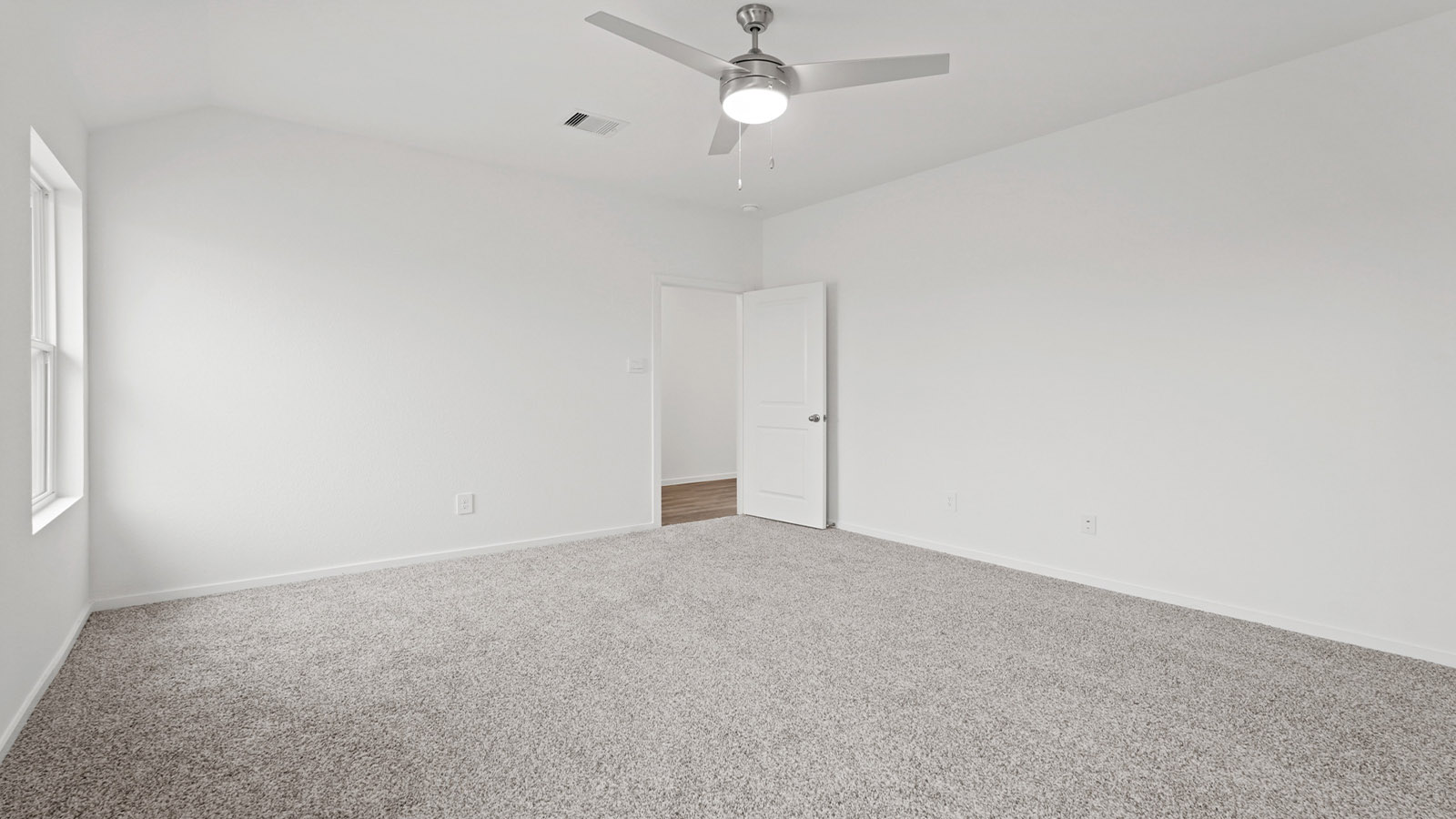 Primary bedroom with carpet flooring