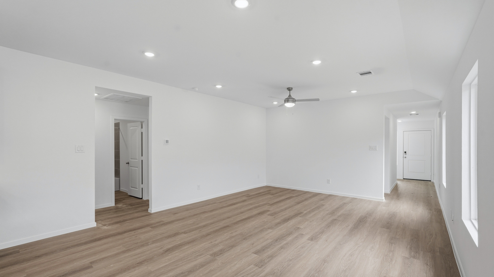 open concept living and dining area with backsplash, quartz countertops, and stainless steel appliances